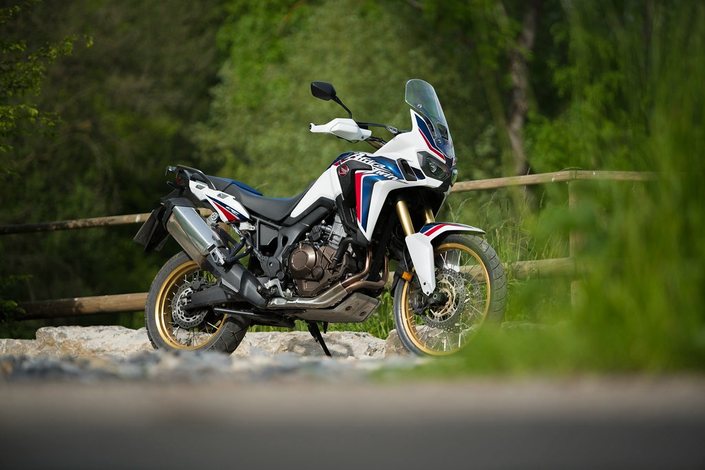 A honda adventure bike parked on the side of the street