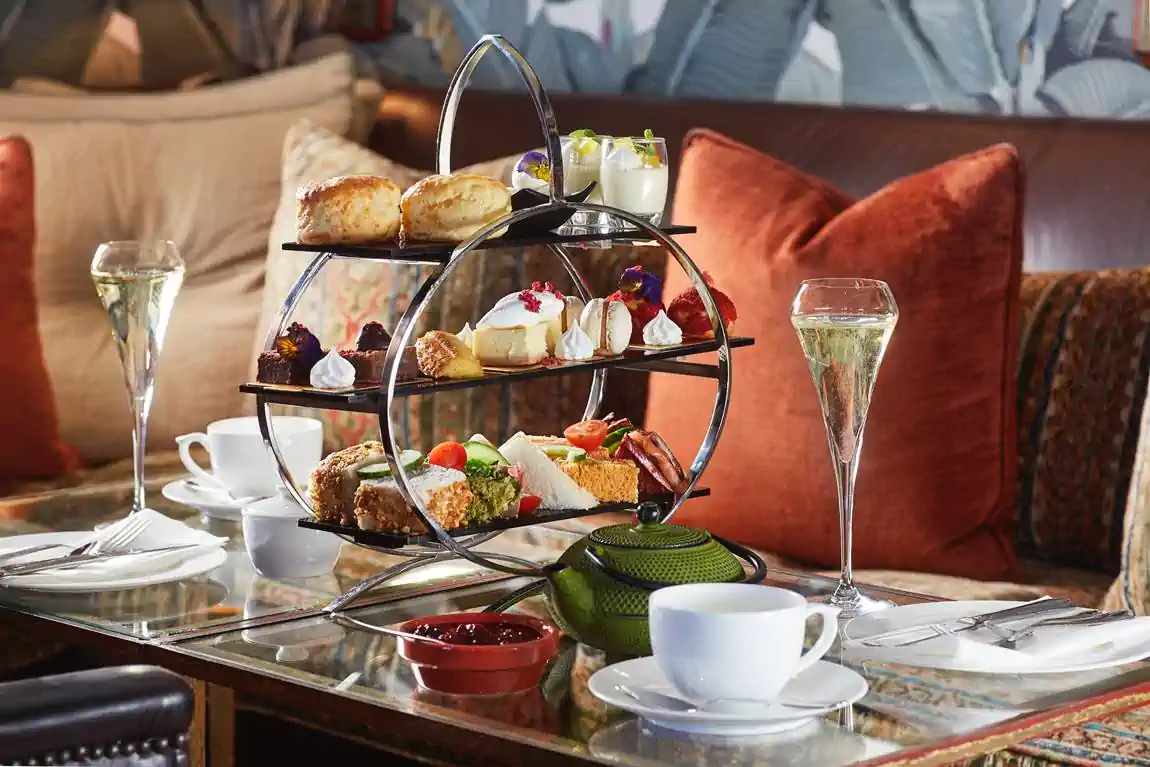 A sophisticated setup of classic high tea with an array of delicious treats and sparkling drinks. Fabulous Flowers and Gifts