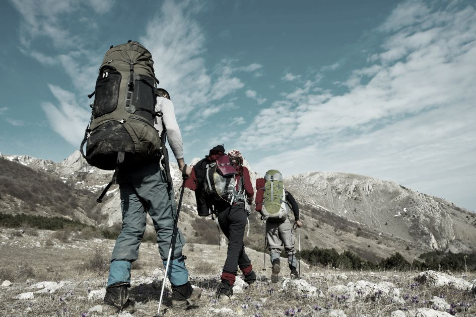 three hikers on a mountain hike 