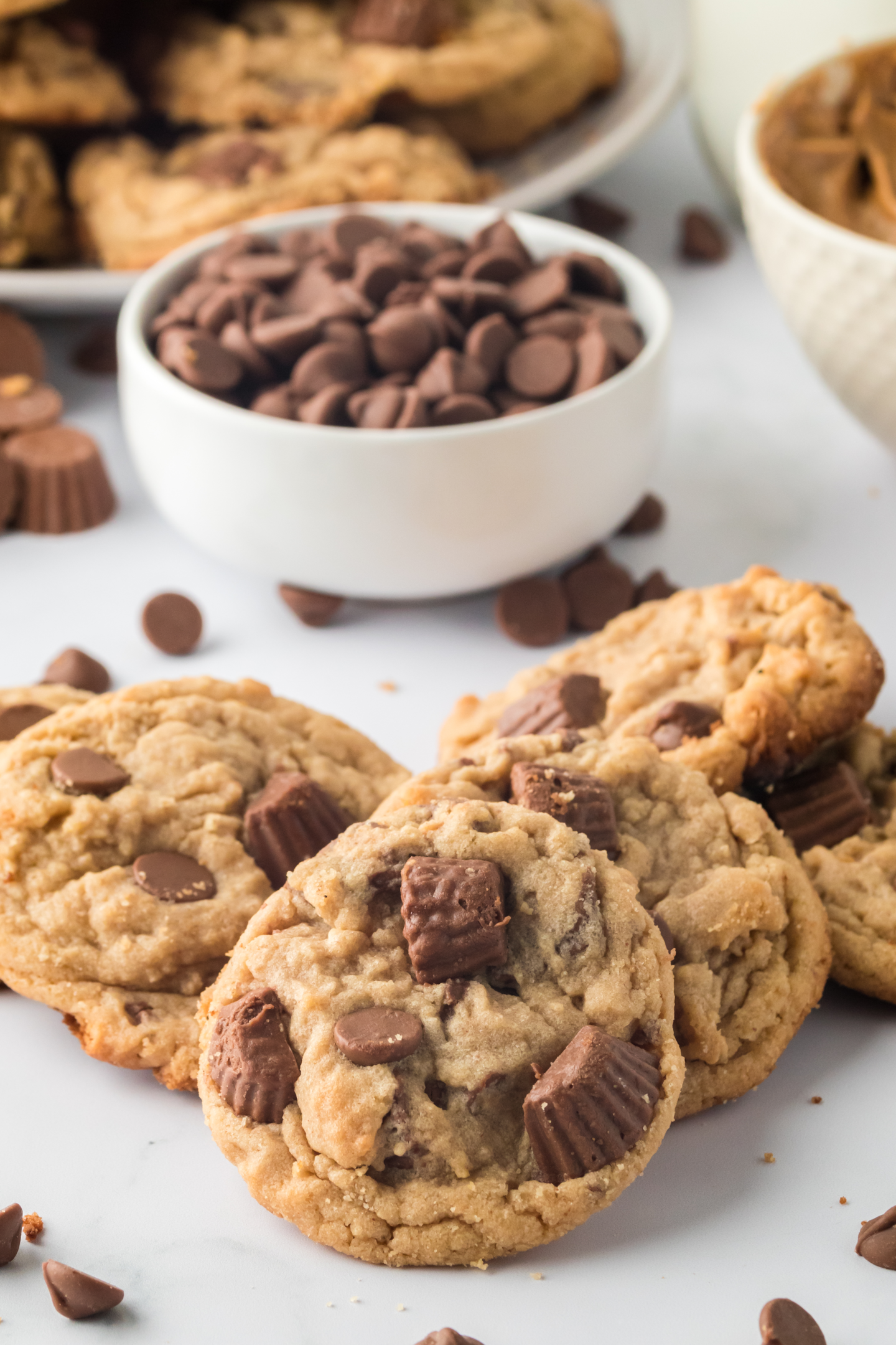 peanut butter cup cookies on a plate with a dish of chocolate chips