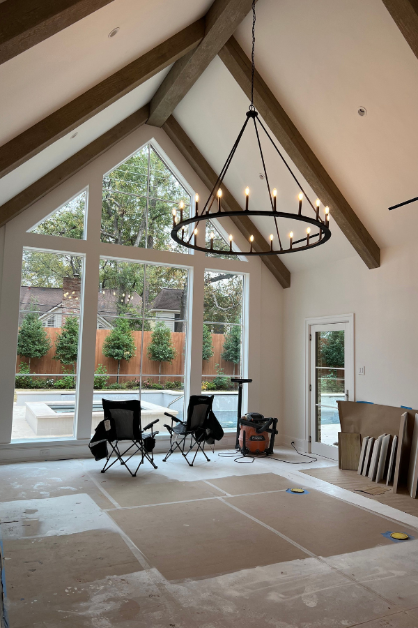 an in-progress shot of a transitional living space, with views to the backyard