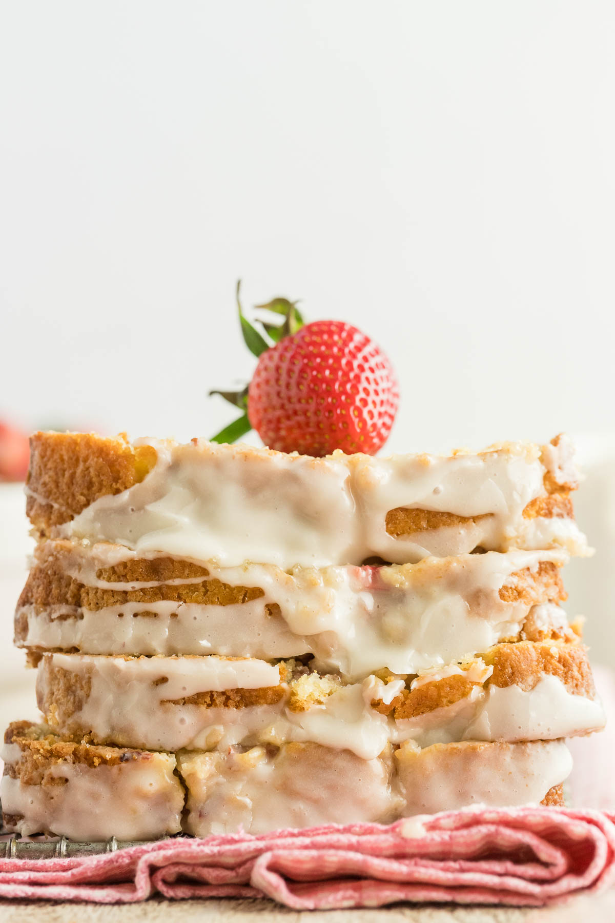 four glazed strawberry bread slices stacked