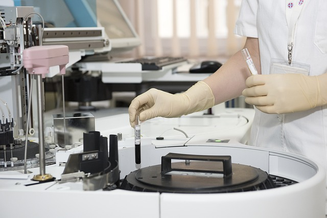 An image of a laboratory, test tubes, and a healthcare worker.