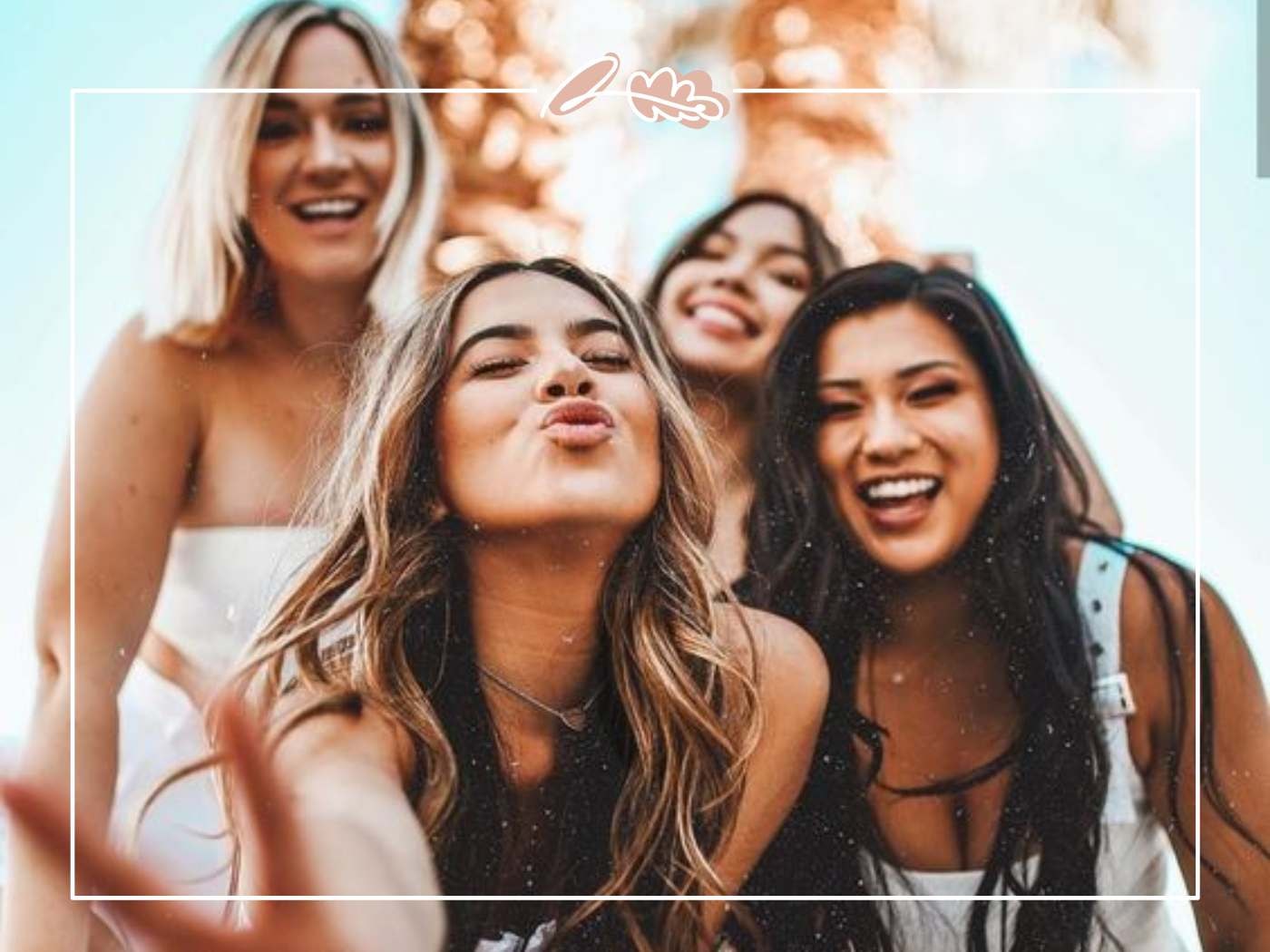 A group of smiling women having fun outdoors, enjoying the sunshine and creating happy memories together.