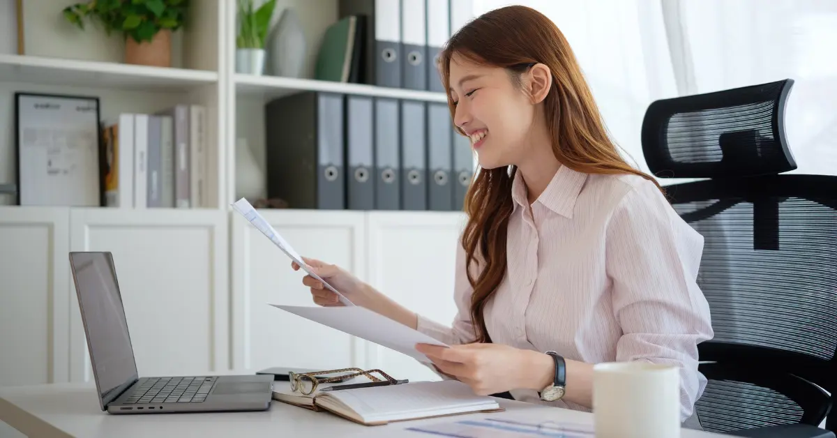 OnlyFans creator reviewing her OnlyFans W2 form and tax documents on a laptop.