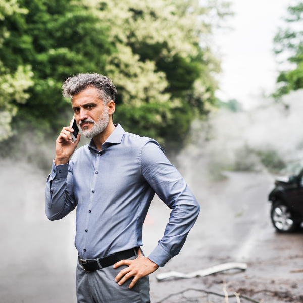 Image of a person on the phone calling the police after an accident with a truck.