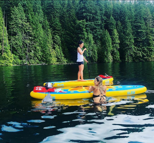two woman on inflatable paddle boards