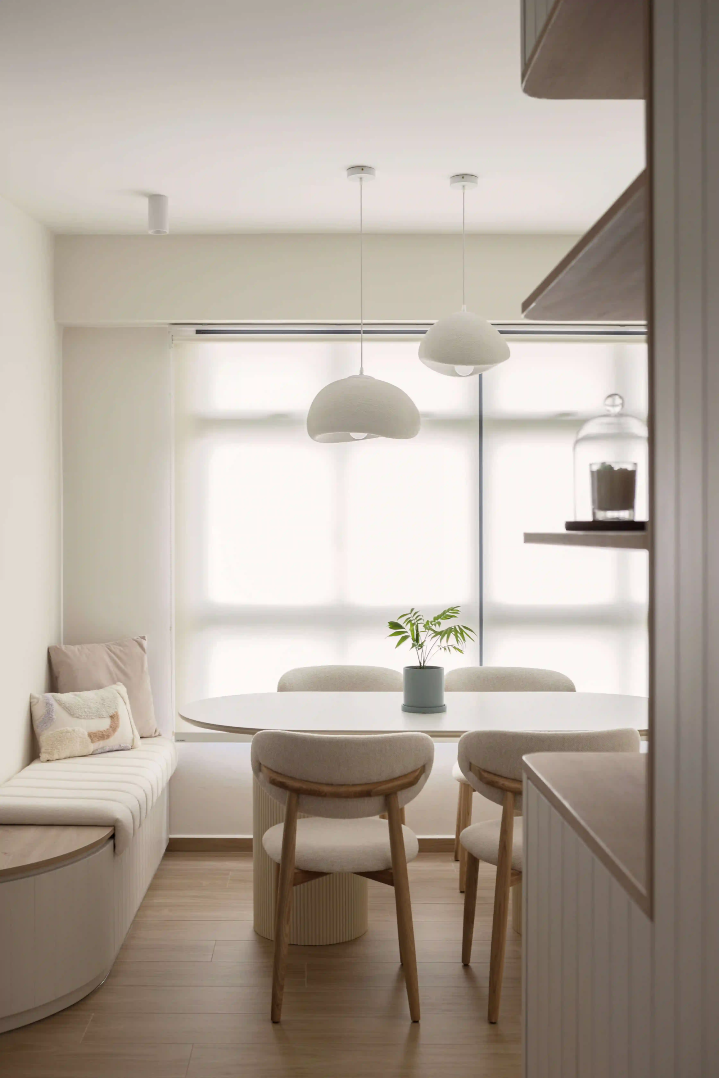 Scandinavian dining nook with built-in bench and pendant lights