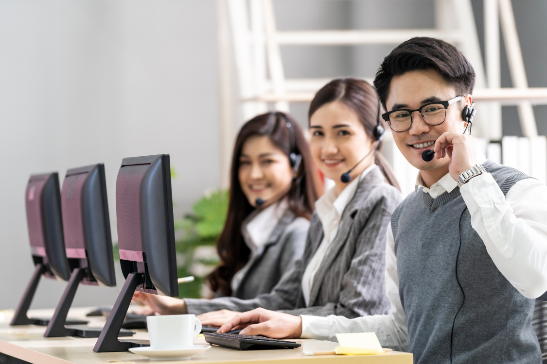 Filipino call center agents with headsets working at their desks