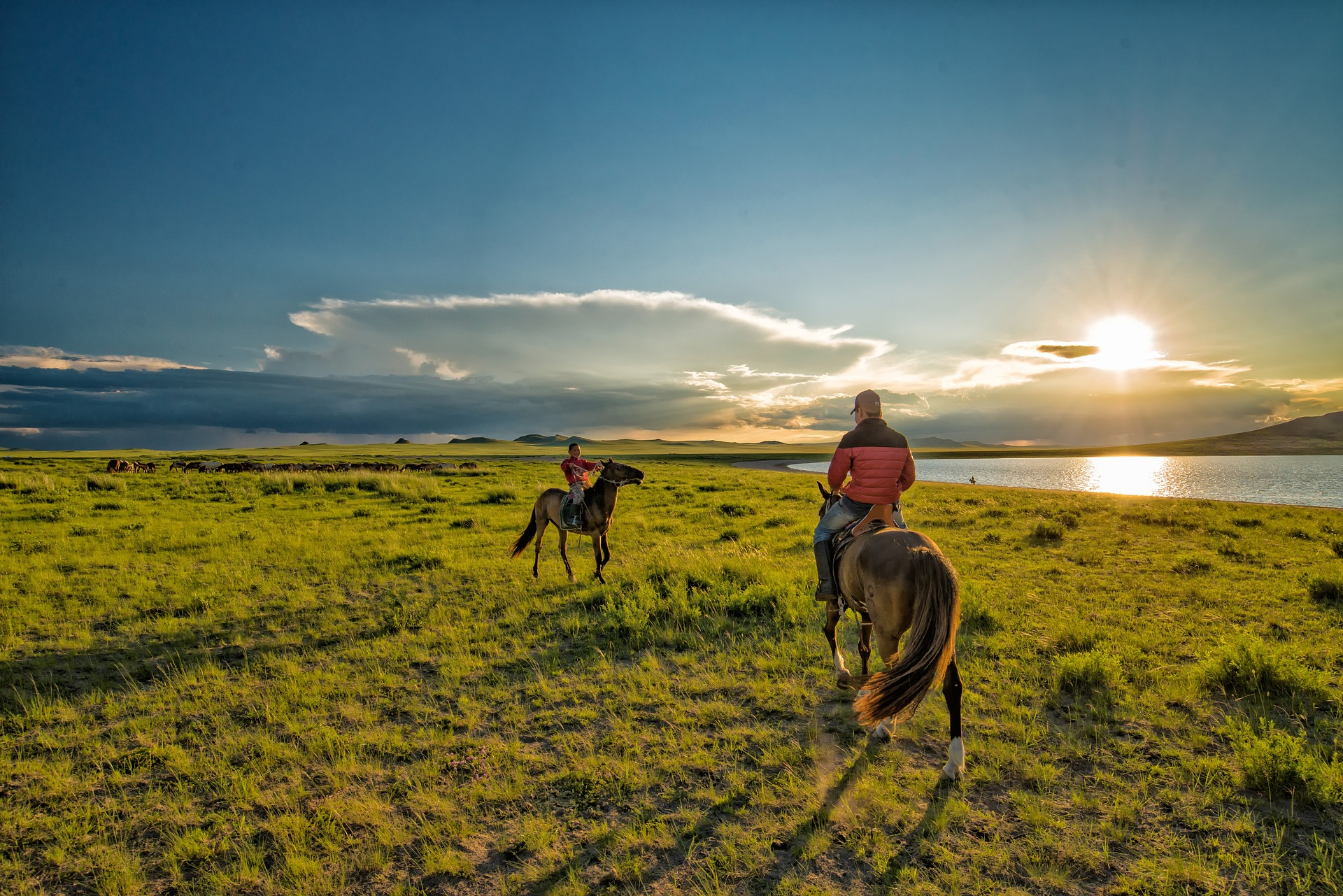 People riding horses on the shore of lake Khuvsgul