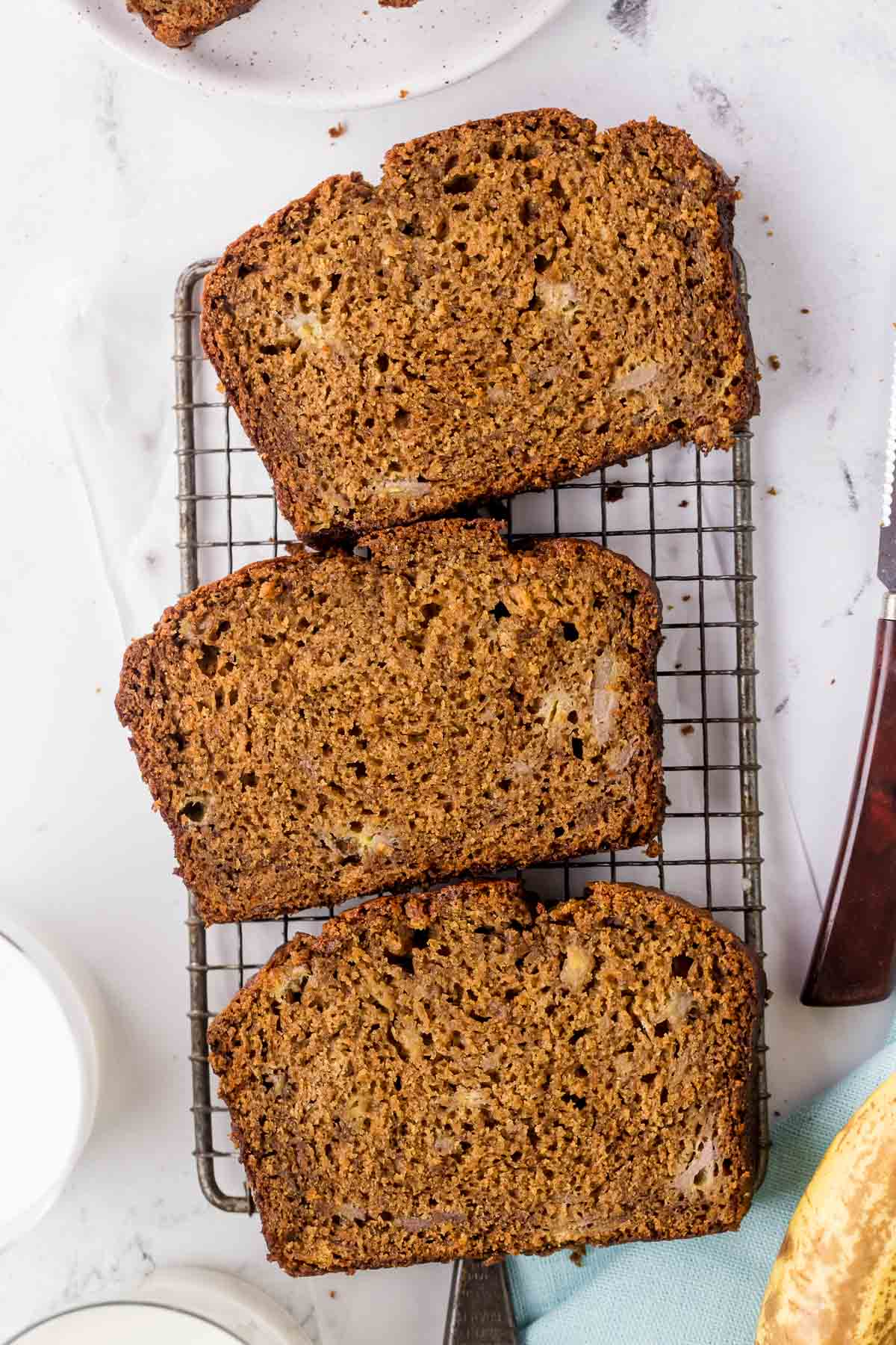 three slices of banana gingerbread on a wire rack