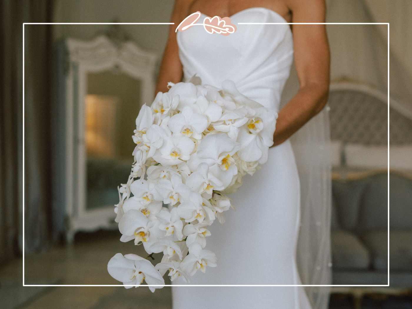 Tess holding her cascading white phalaenopsis orchid bridal bouquet in her ivory wedding gown at Nantes Estate