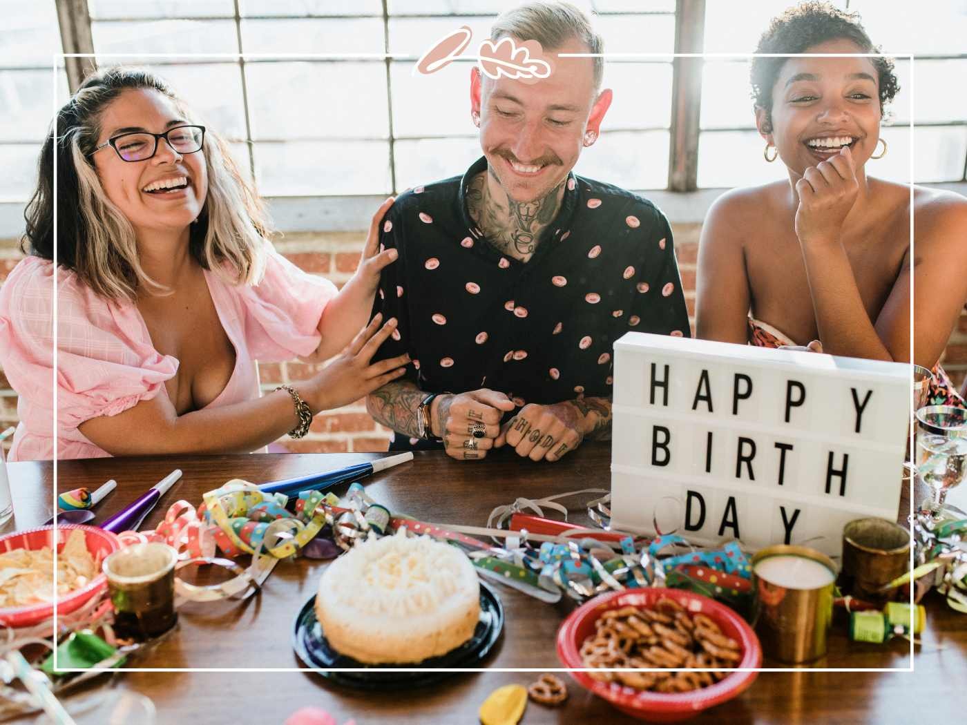 Birthday Wish for Boyfriend – friends laughing with birthday cake, streamers and a “Happy Birthday” lightbox on the table