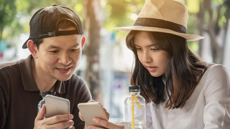 Tourists using their phones reading 90 Day Korean review from Ling.