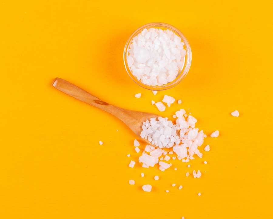 MSM (Methylsulfonylmethane): A Guide to Benefits, Dosage, and Safe Usage – crystals in bowl and spoon on yellow.