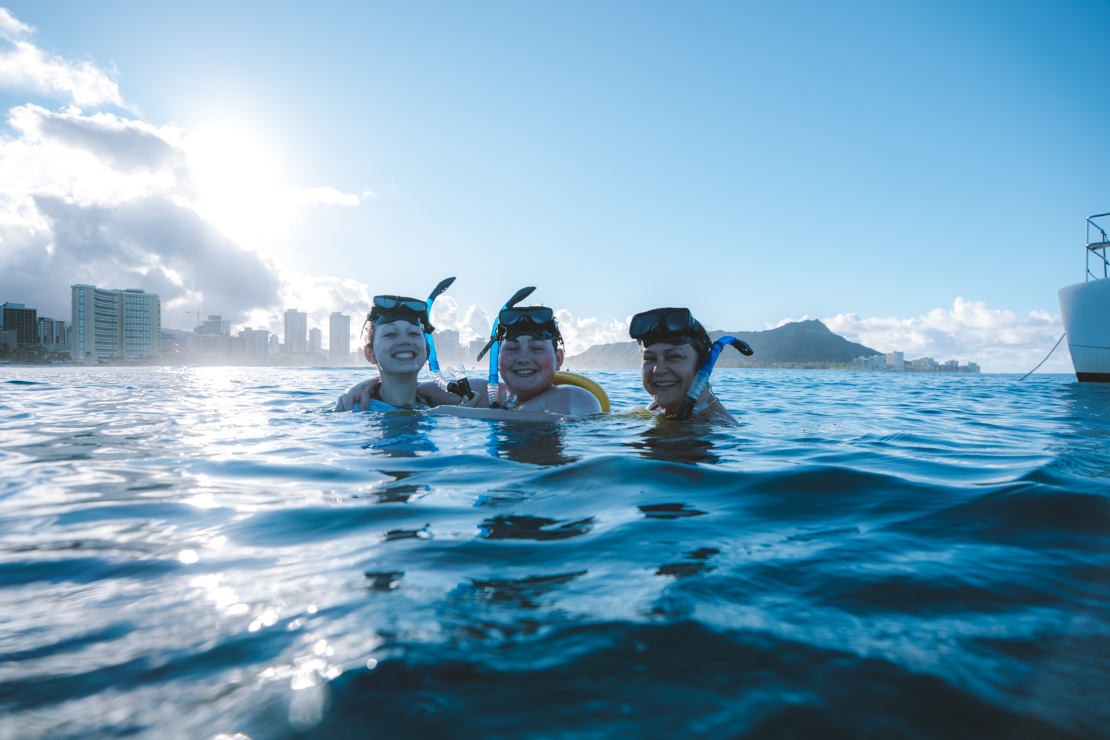 Snorkelers Swimming at the surface, smiling.