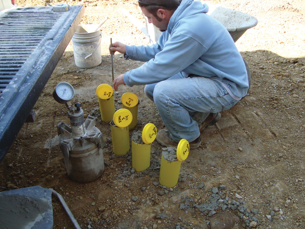 A concrete cylinder test specimen being prepared for testing