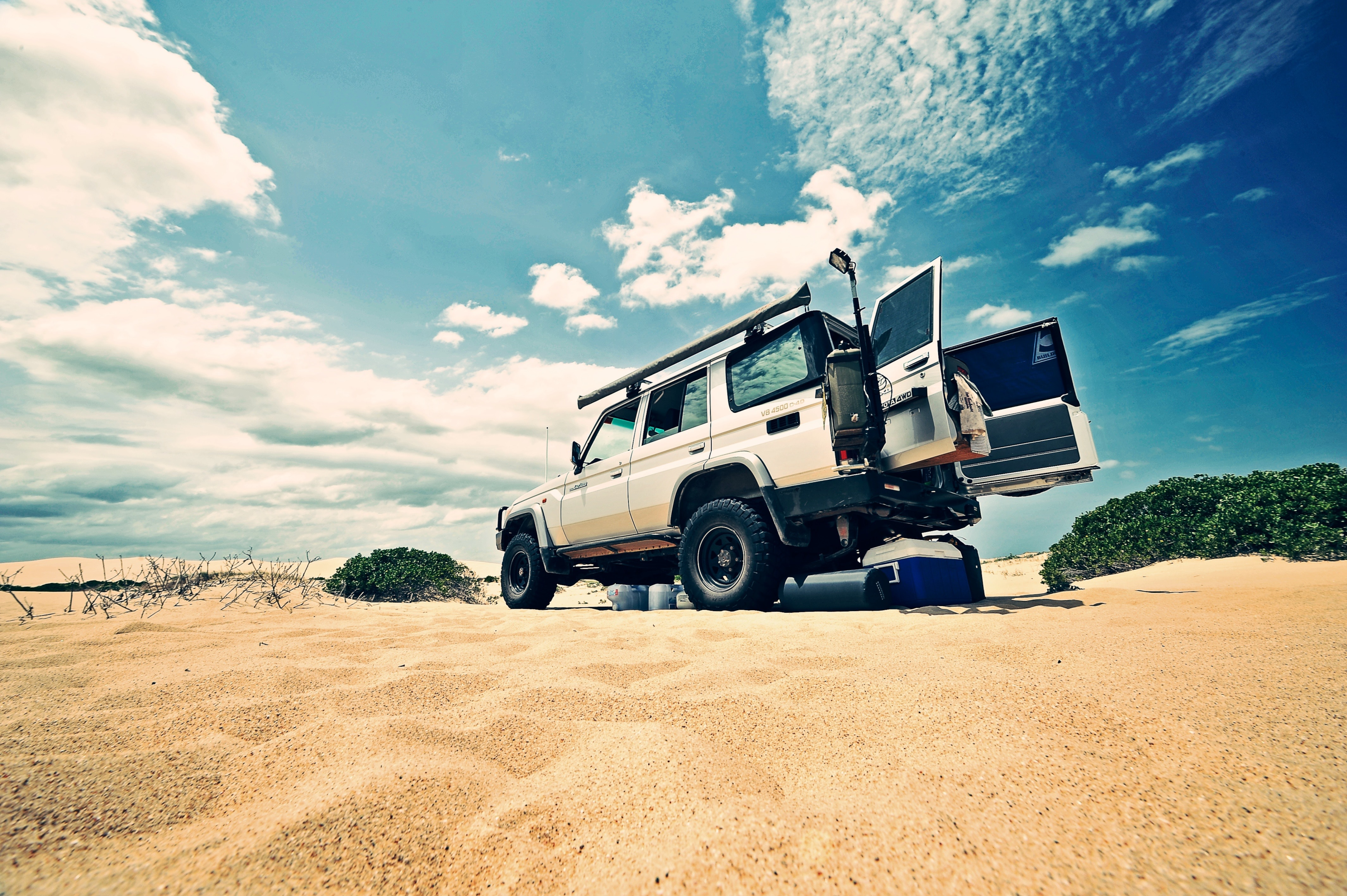 A Toyota Land Cruiser driving on a rocky terrain