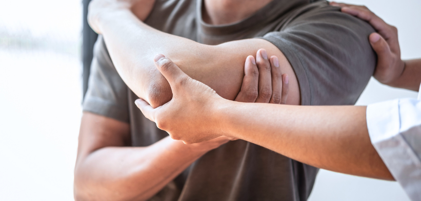 Clinician examining a patient’s elbow joint, checking tenderness and range of motion.