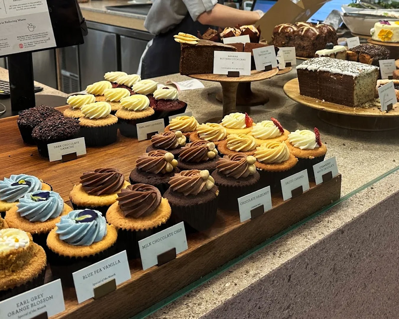 An inviting display of assorted muffins in classic flavours, baked to golden perfection and arranged neatly in a bright bakery counter.