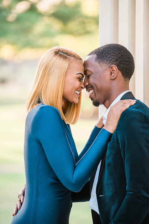 A playful engagement photoshoot featuring a couple laughing together.