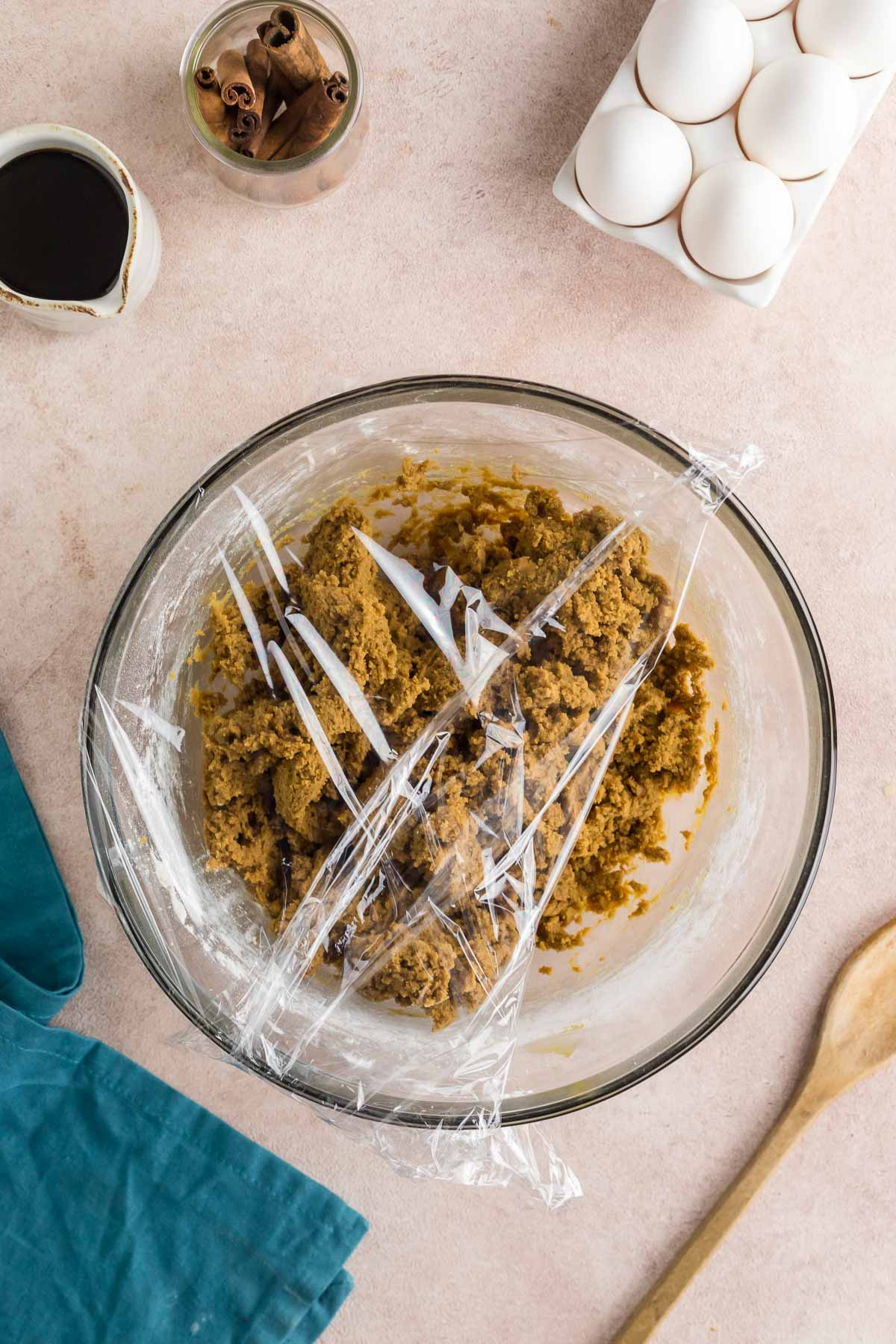 bowl of molasses dough covered with plastic wrap