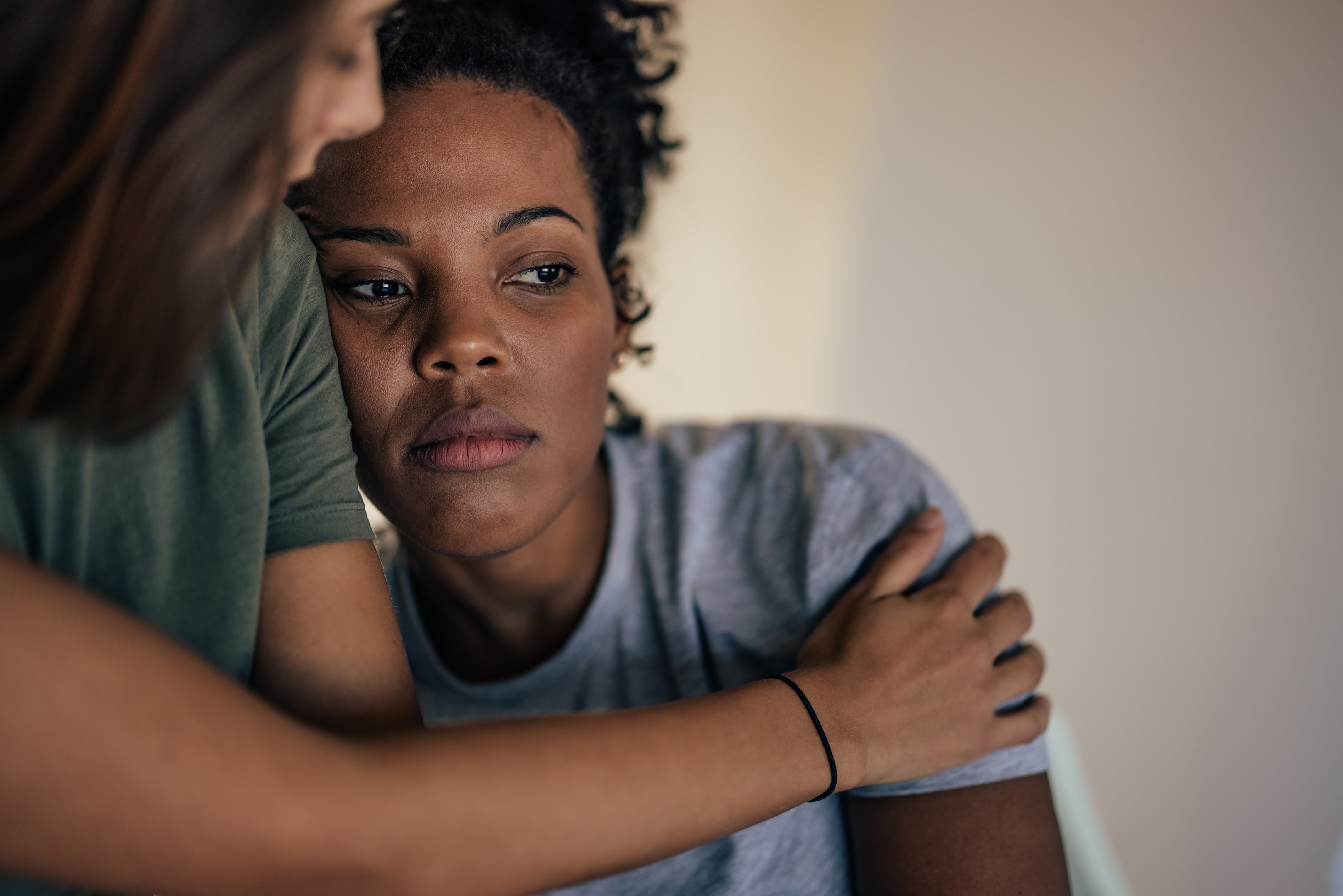 A woman being comforted by a friend, highlighting the importance of emotional support when navigating family history and Managing Depression Symptoms in The Woodlands