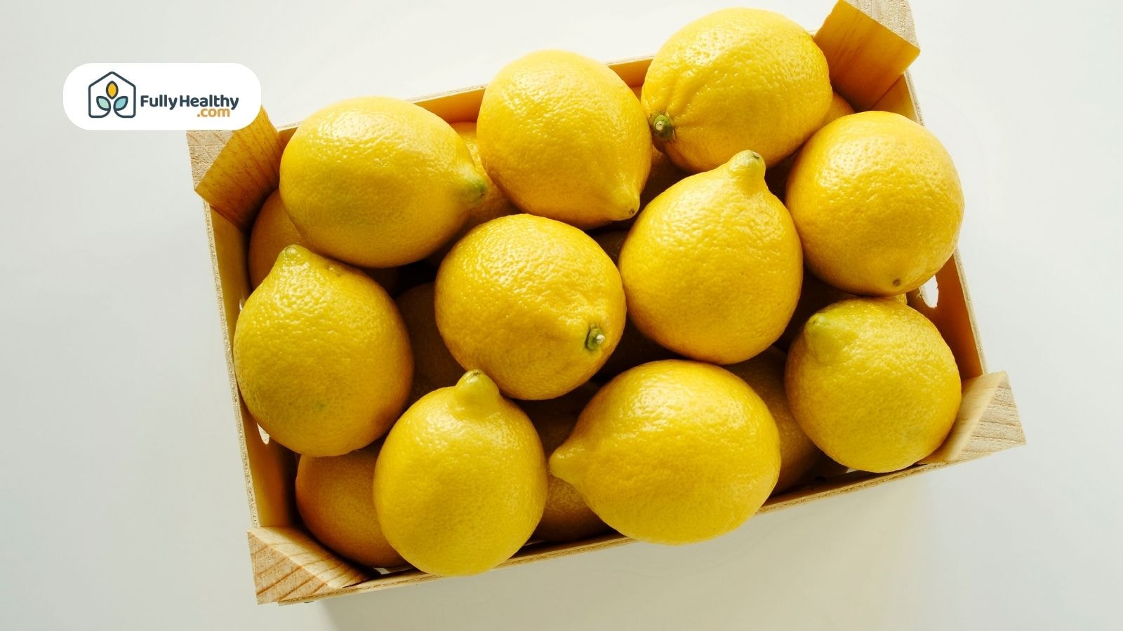Wooden crate filled with fresh yellow lemons