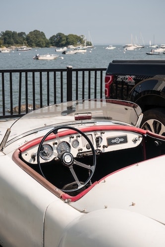 One of the many recreational opportunities available in Greenwich: fishing next to luxury convertibles