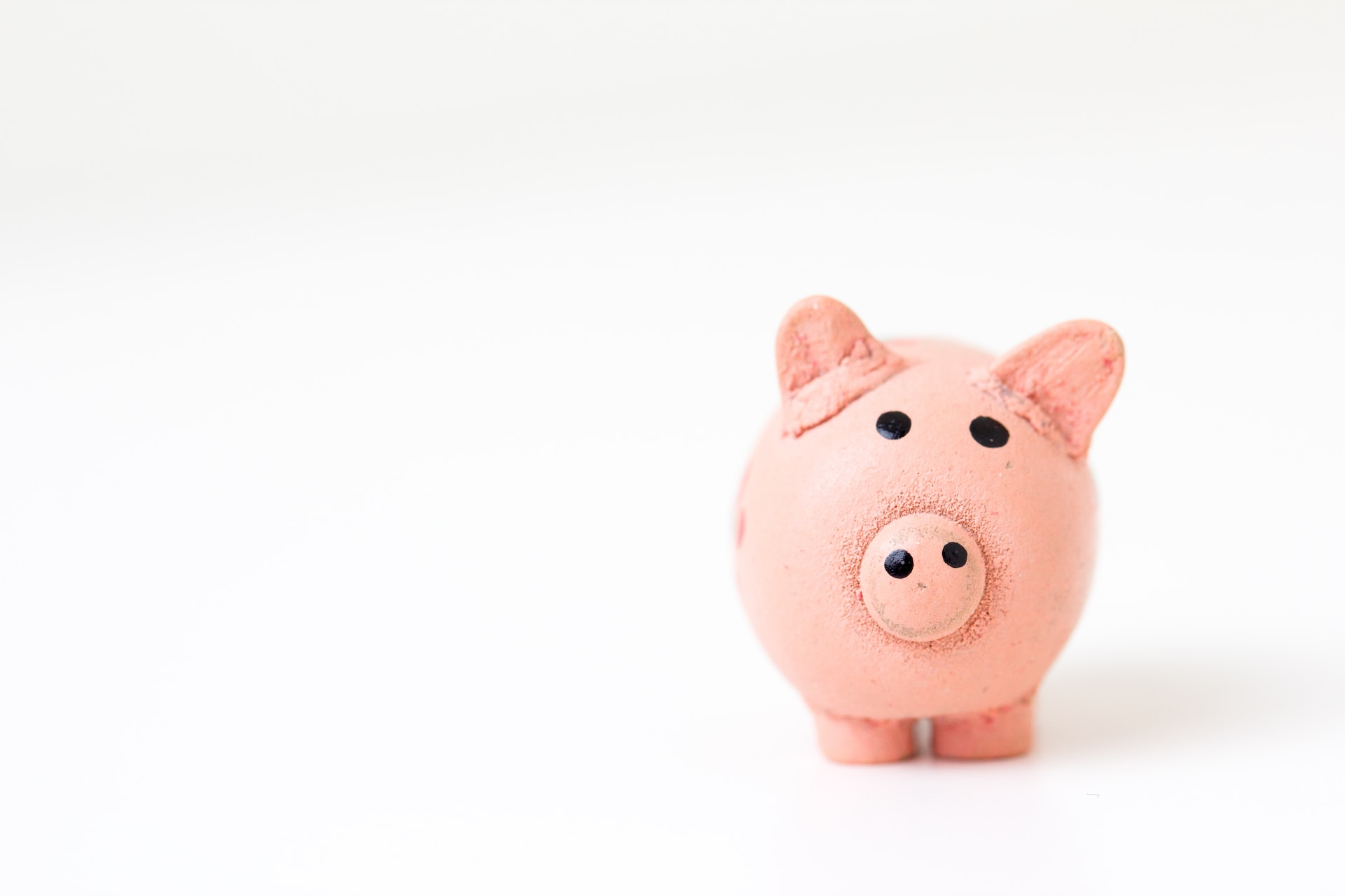 A minimal photo of a pink piggy bank on white background