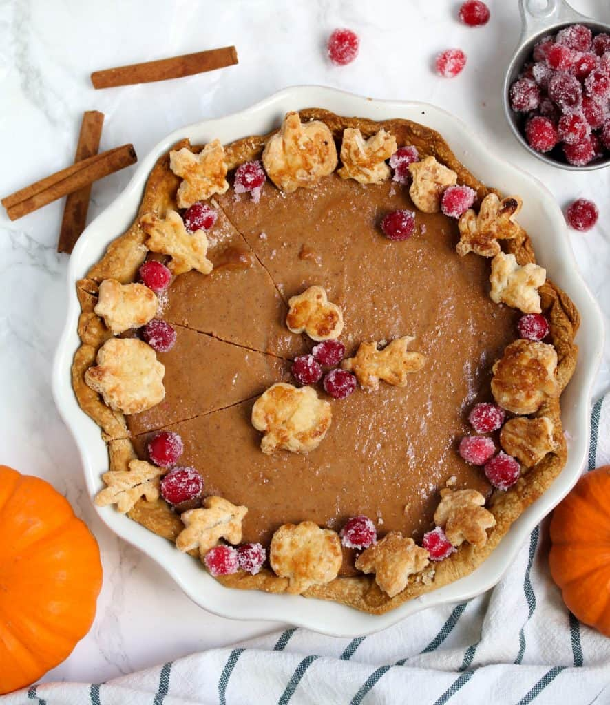 whole pumpkin pie topped with sugared cranberries