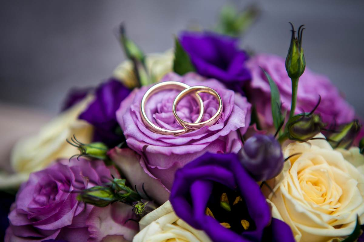 lavender rose bridal bouquet, wedding rings, lisianthus, meaning of flowers