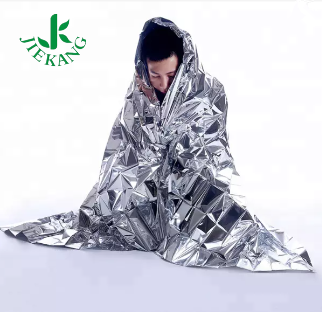 Person wrapped in silver emergency blanket