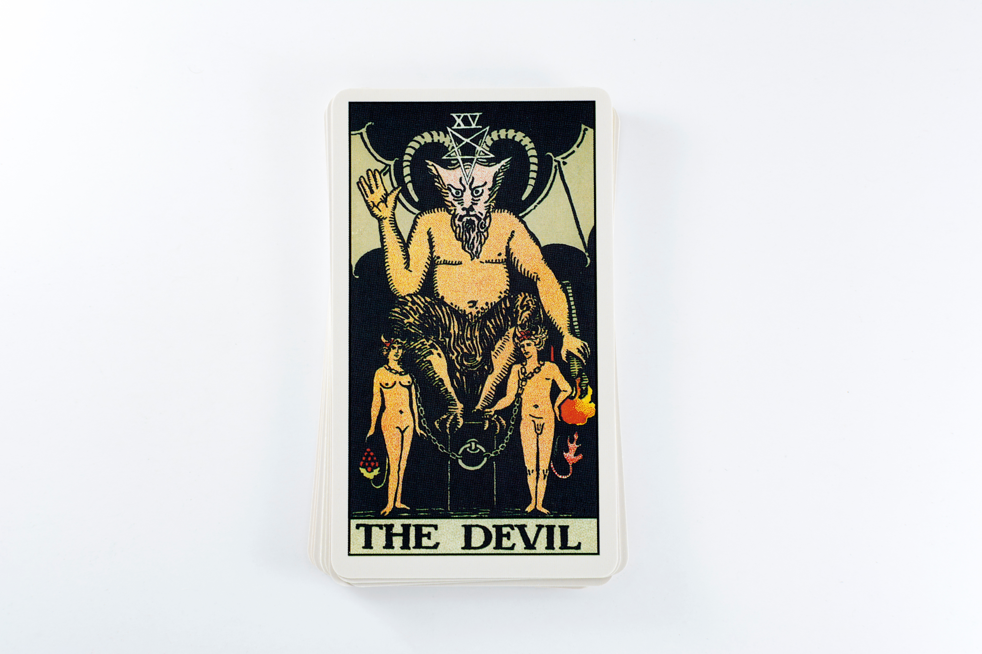 the devil tarot card, angry horned demon with two nude figures beneath him