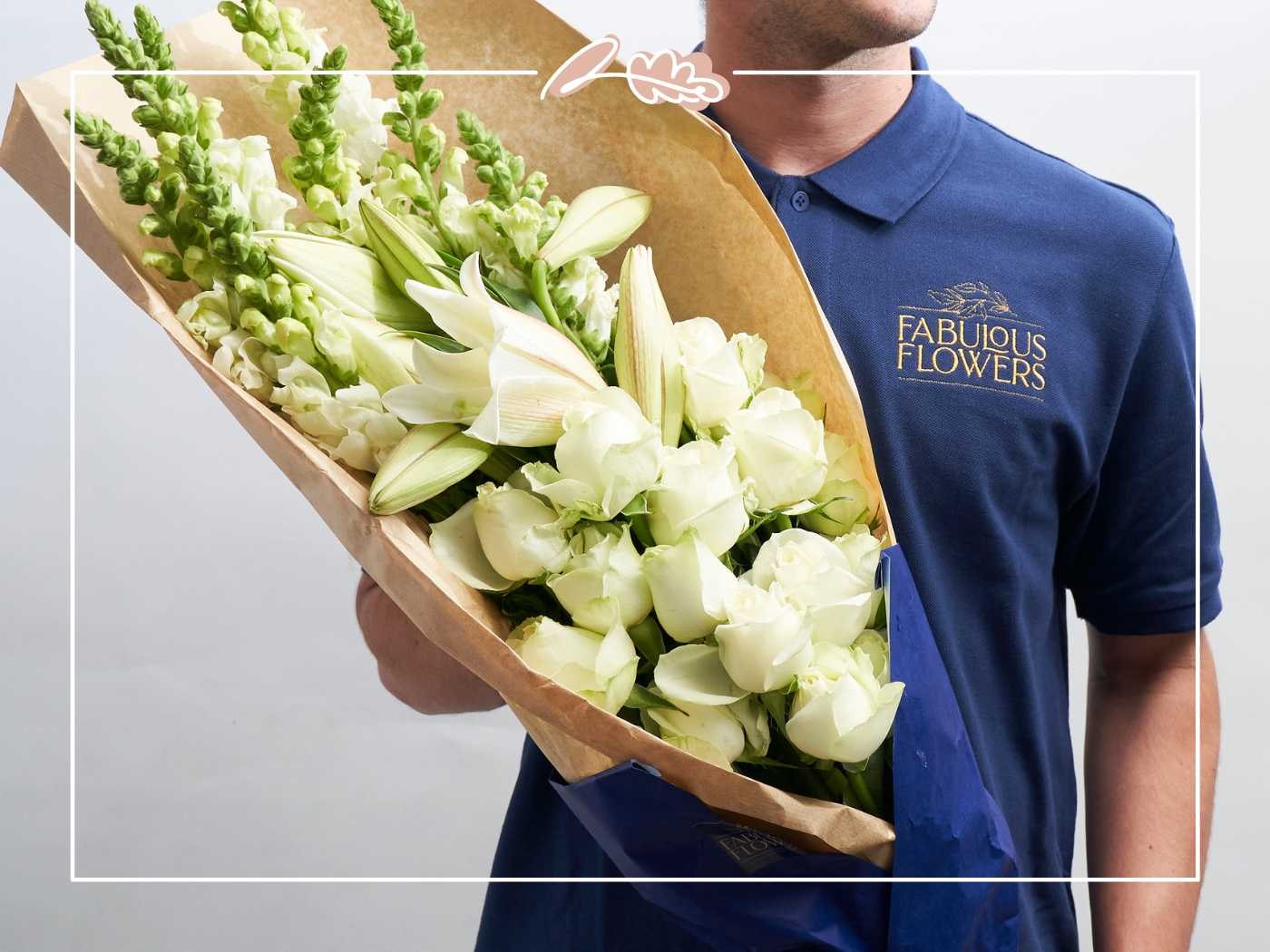 Person holding a bouquet of white flowers by Fabulous Flowers and Gifts