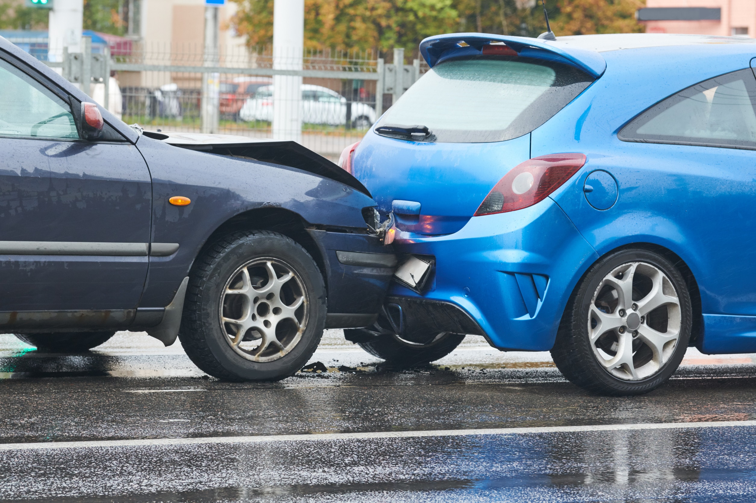 Distracted driving causes a blue car to crash into the back of another, causing a rear end collision