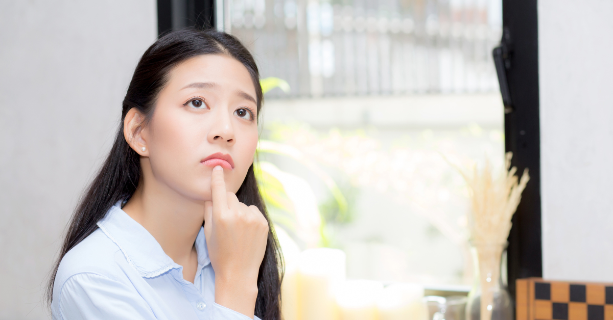 A woman thoughtfully considering her tax responsibilities and asking do I need to report income under 600 onlyfans