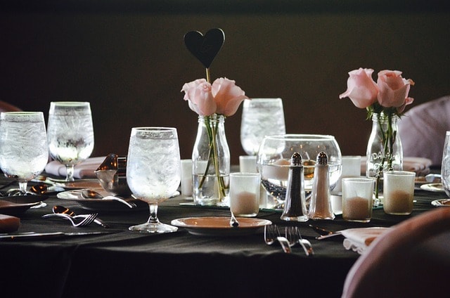 Table set for wedding reception with wine glasses filed with ice