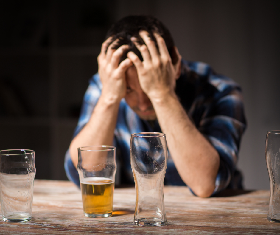               A person looking away from a glass of beer, symbolizing the preparation for challenges and relapses
