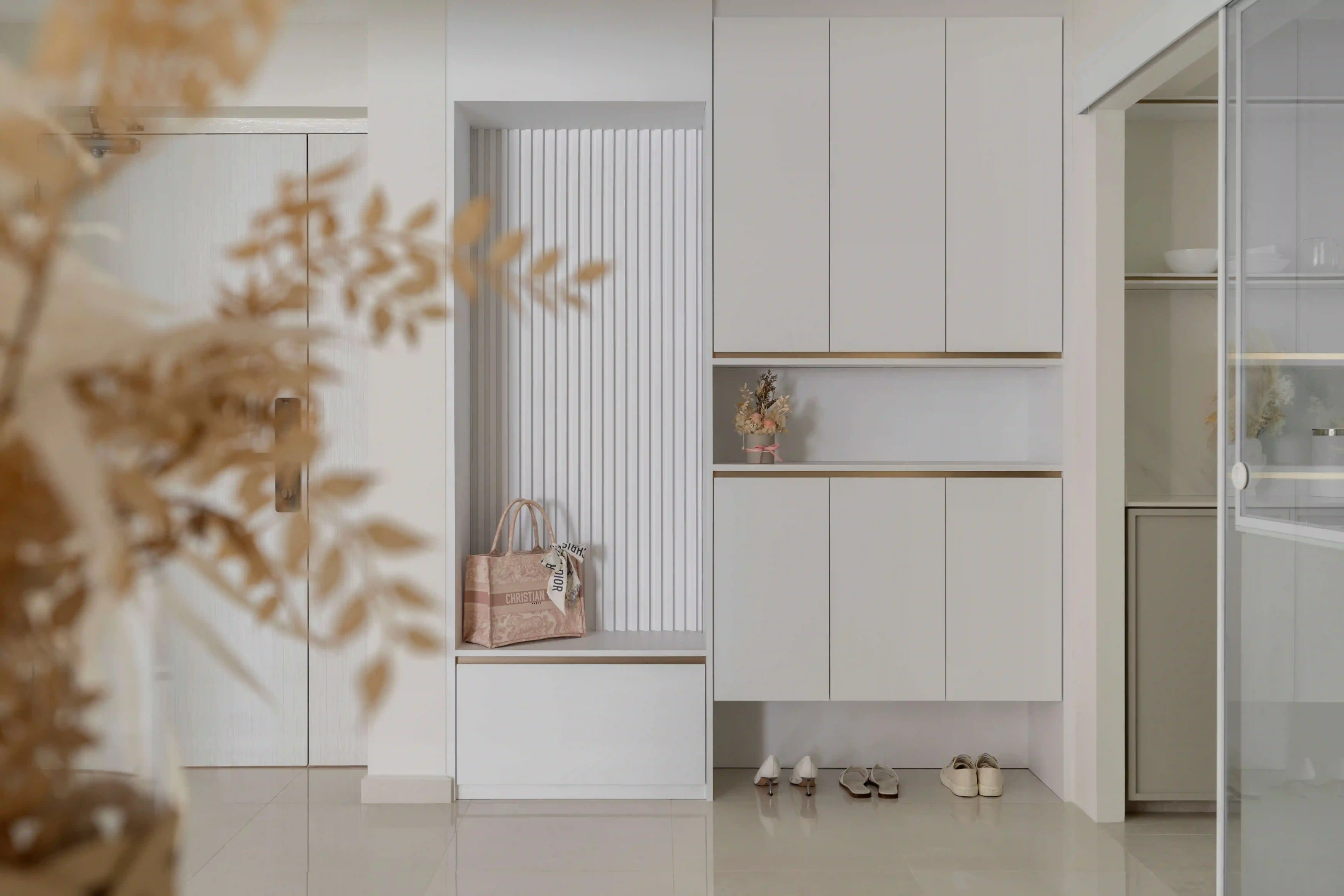 Minimalist condo entryway with concealed smart locks and built-in shoe cabinet