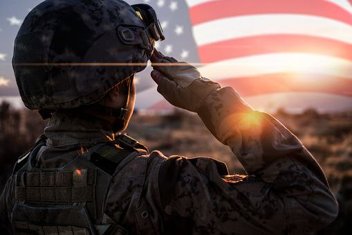 A soldier saluting the American Flag 