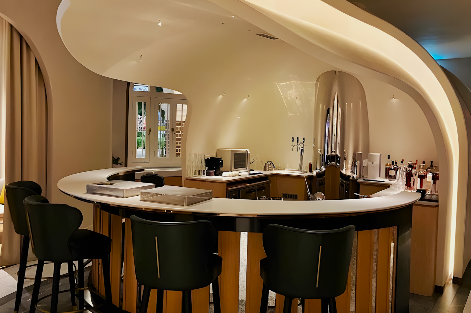 Sleek, modern curved bar with soft white lighting and black chairs. Features minimalist decor and liquor bottles, creating an inviting ambiance.