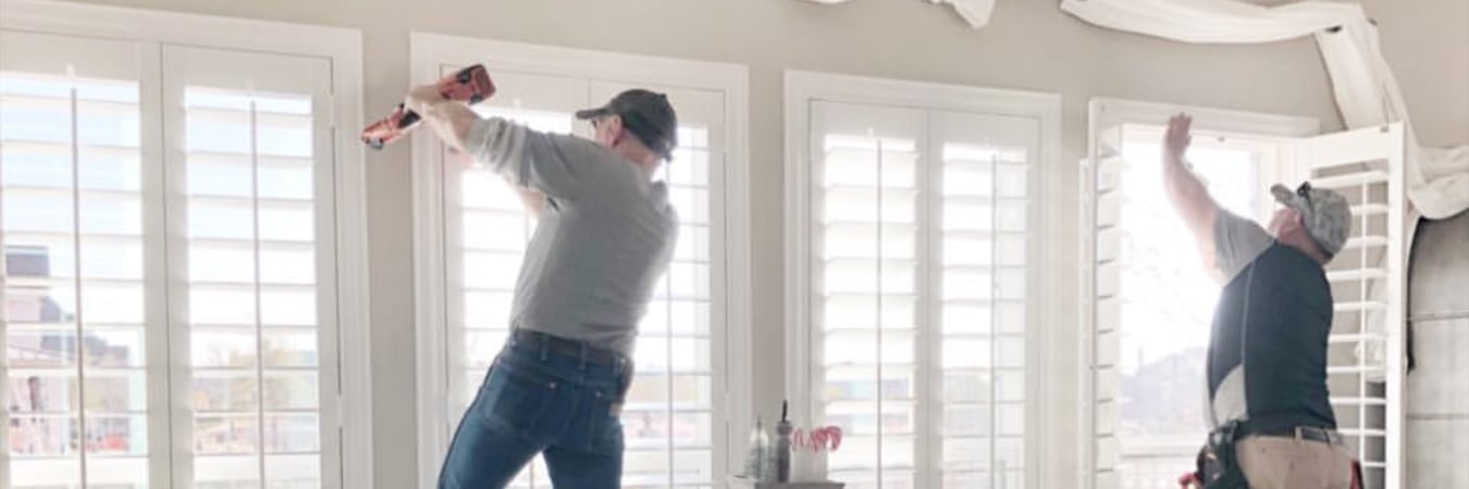 Men installing plantation shutters