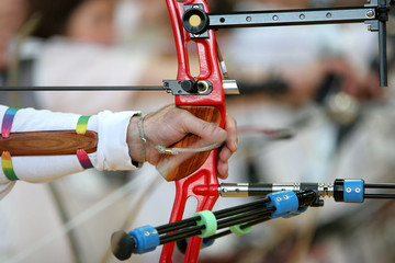 Olympians holding recurve bows at the Olympics