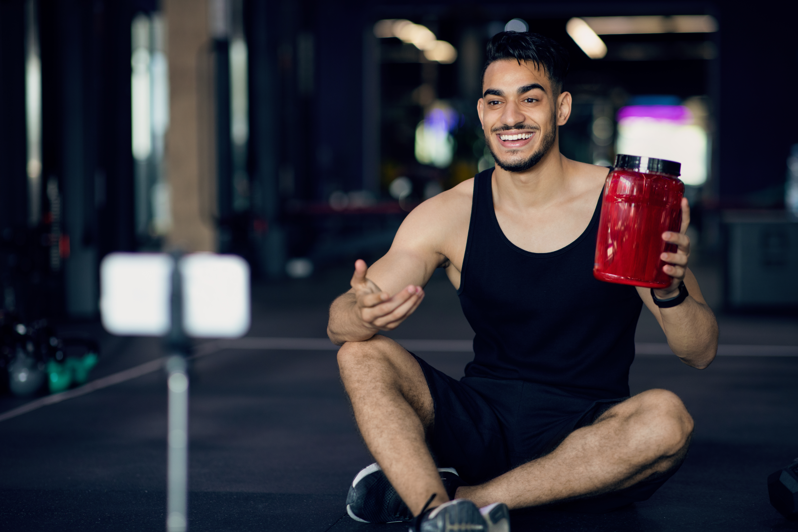 Fitness trainer filming video about protein powder