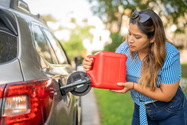 Person refueling a car