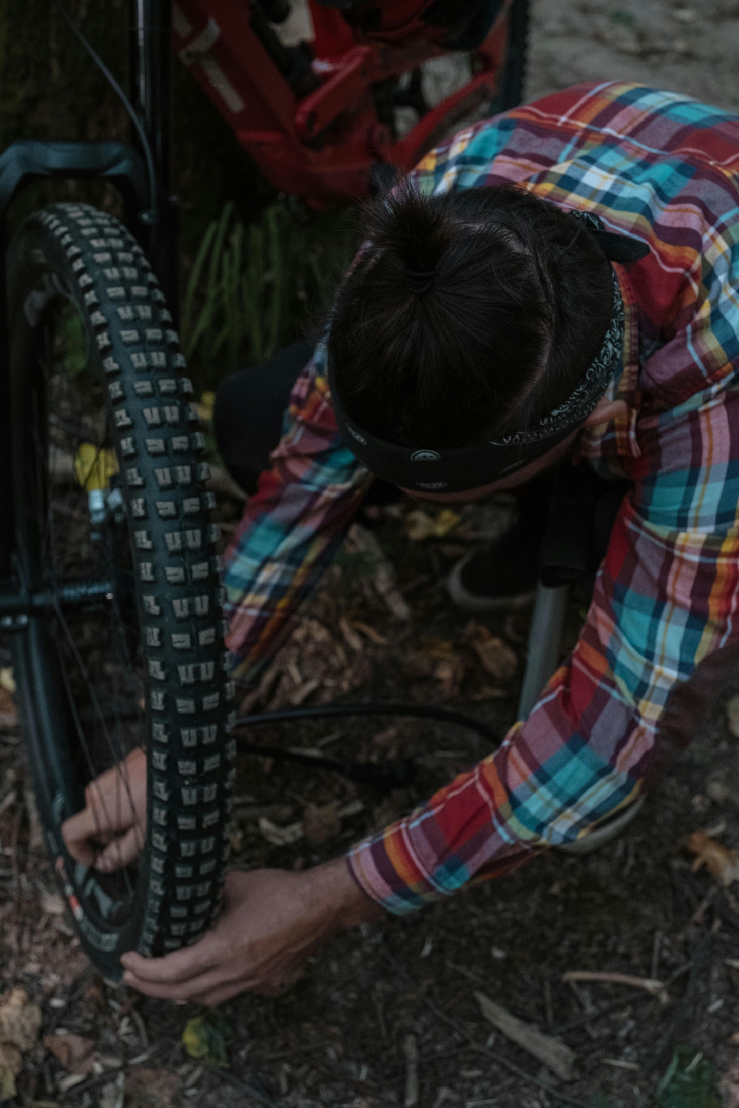 Mountain bike rider checking tire