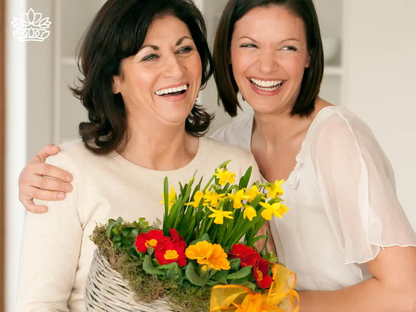 Mother and daughter sharing a joyful moment with a beautiful basket of flowers. Fabulous Flowers and Gifts