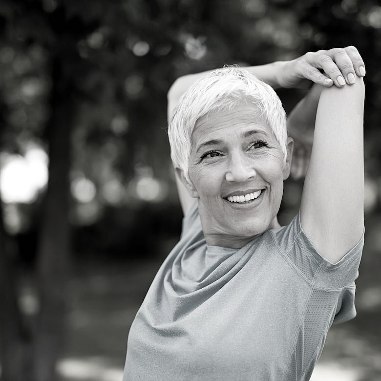 Older woman doing a tricep stretch
