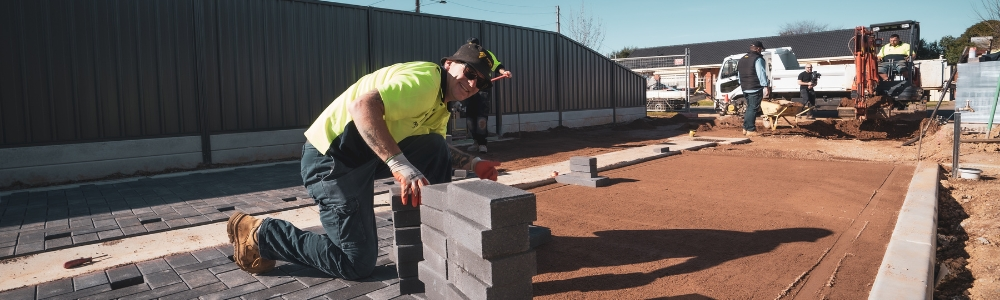 A paving contractor performing routine maintenance on a driveway